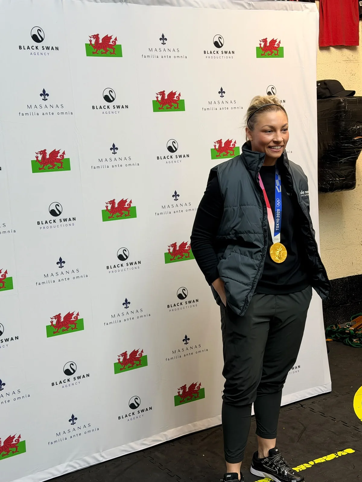 Lauren Price MBE in front of the MASANAS and Black Swan backdrop
