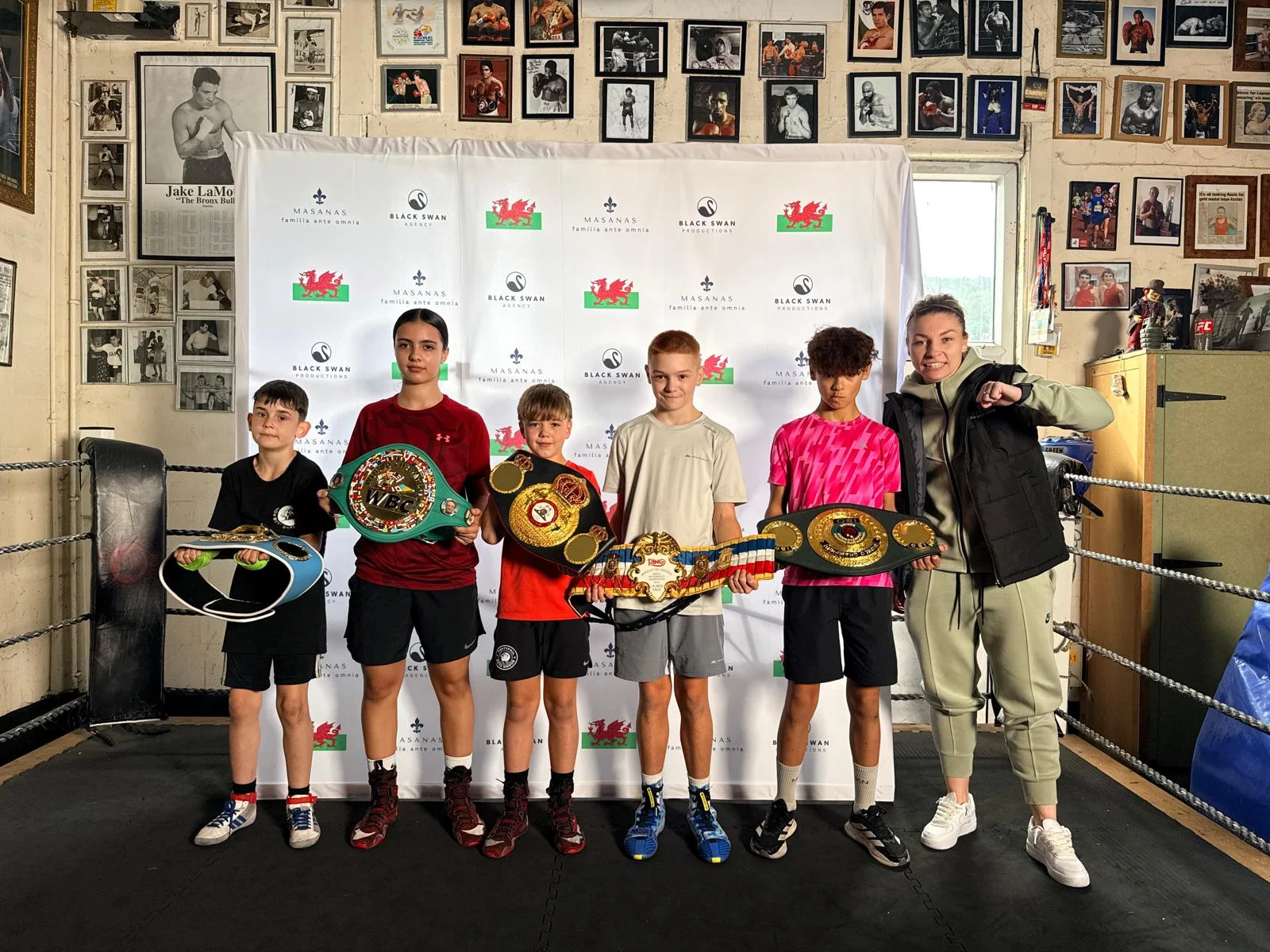 Young boxers with championship belts and Lauren Price MBE